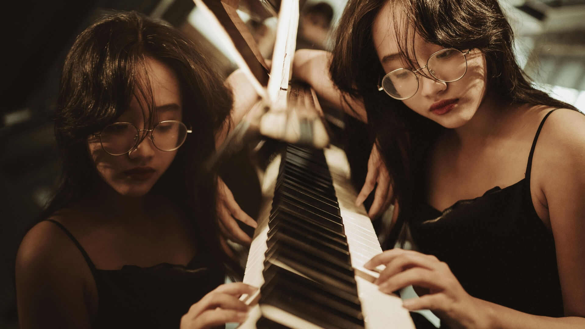 a woman lying on piano